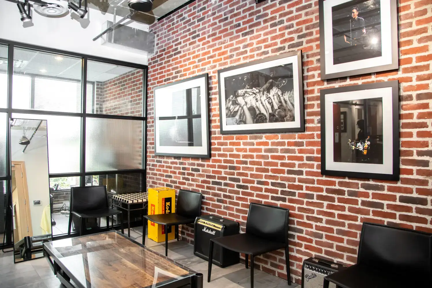 Belman Dental Centre waiting area with exposed brick, concert photography, and a Marshall amplifier