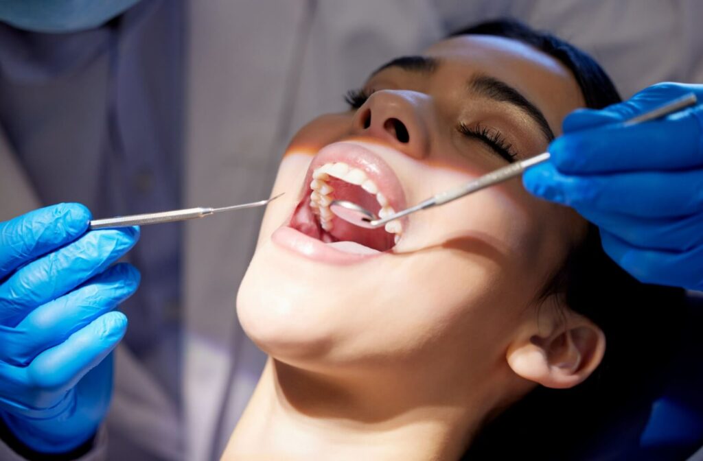 A dental hygienist performs a thorough oral examination before beginning the professional dental cleaning.