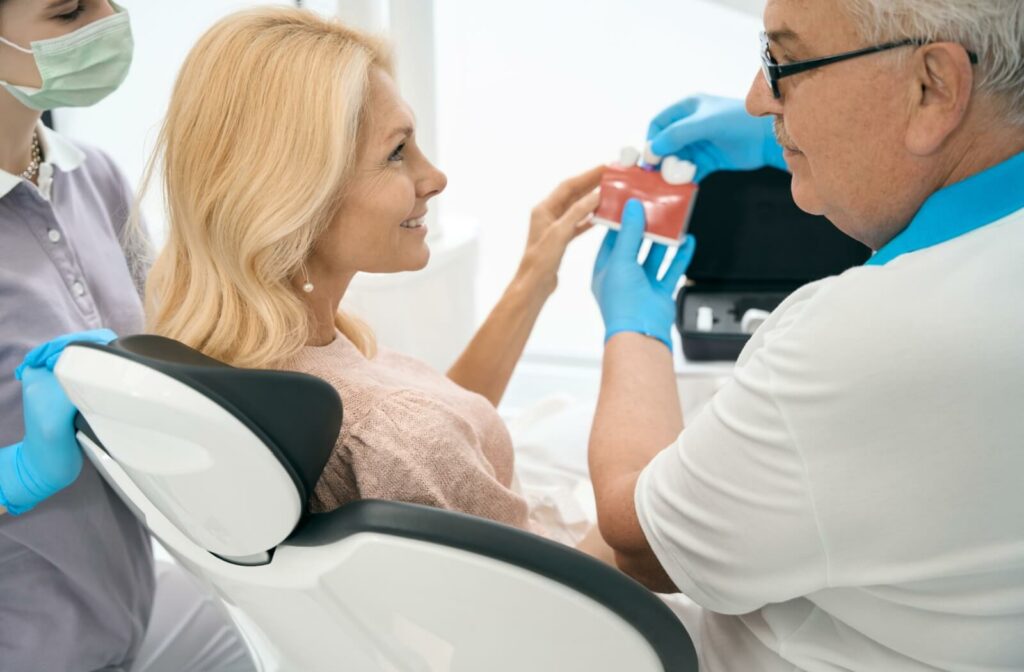 Dentist demonstrating dental implants to a patient in their clinic.