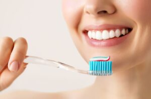 Someone gets ready to brush their teeth and prevent cavities.