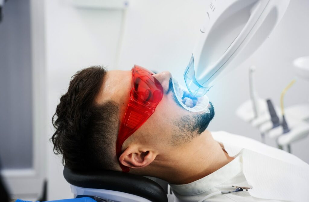 Cosmetic_dental_procedures_in_toronto_whats_trending_in_2025_supporting 1 | Belman Dental Centre A man getting teeth whitening treatment at a dental clinic.